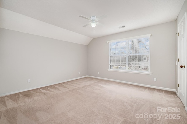 interior space with lofted ceiling, light colored carpet, and ceiling fan