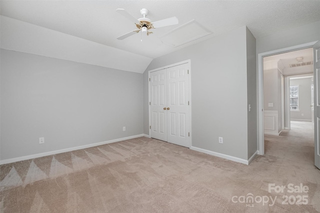 additional living space featuring light carpet, lofted ceiling, and ceiling fan