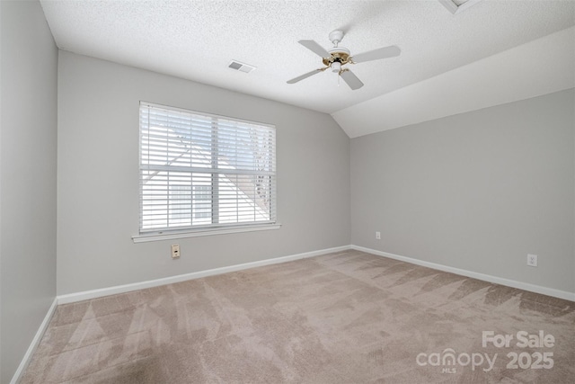 bonus room with ceiling fan, lofted ceiling, light colored carpet, and a textured ceiling