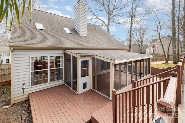 wooden deck featuring a sunroom