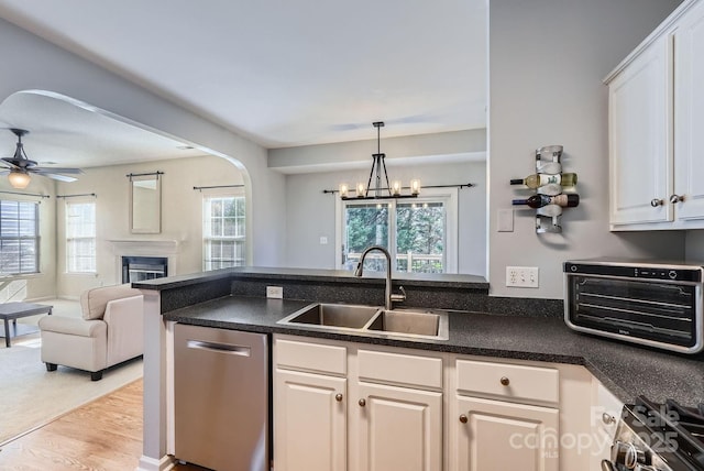 kitchen featuring white cabinetry, ceiling fan, appliances with stainless steel finishes, and sink