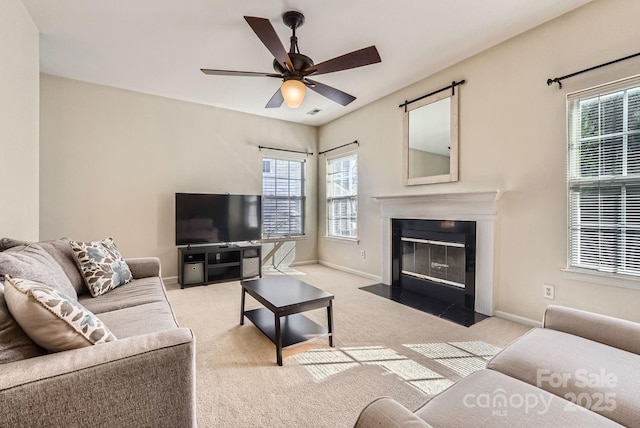 living room with light colored carpet and ceiling fan