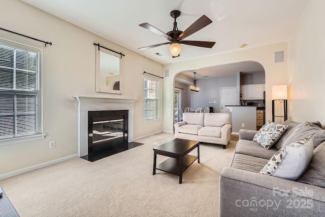 carpeted living room featuring ceiling fan