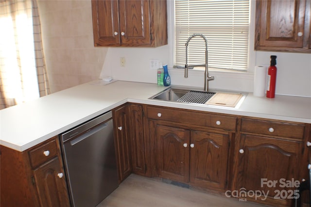 kitchen with dishwasher, sink, and kitchen peninsula