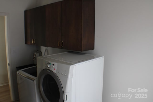 laundry area featuring cabinets and separate washer and dryer