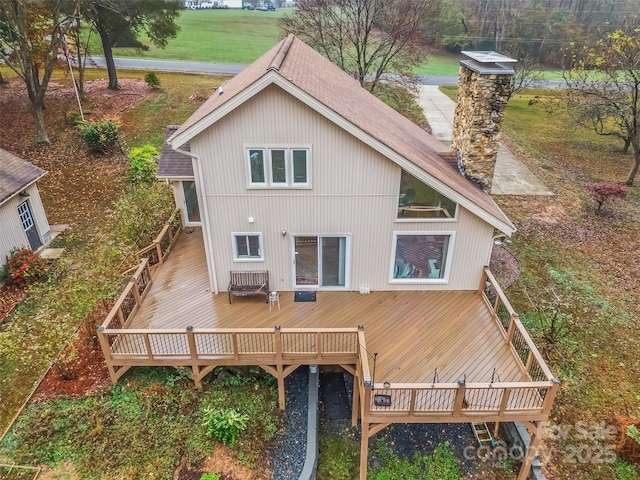 rear view of house featuring a wooden deck