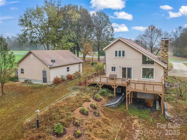 rear view of house featuring a wooden deck