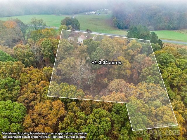 birds eye view of property with a rural view