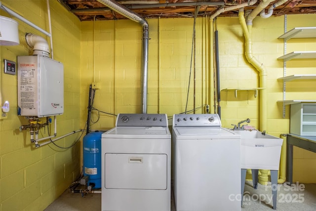 laundry area featuring sink, washing machine and dryer, and water heater