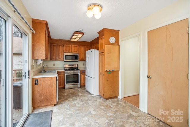 kitchen featuring a healthy amount of sunlight, stainless steel appliances, and sink