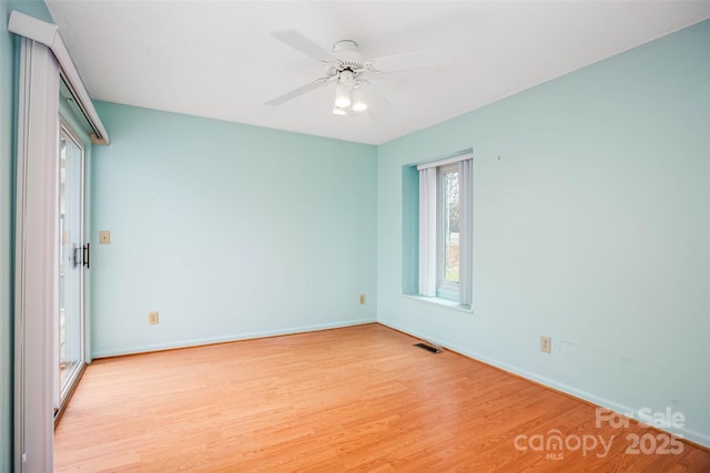 empty room featuring ceiling fan and light hardwood / wood-style floors