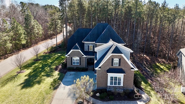 birds eye view of property featuring a view of trees