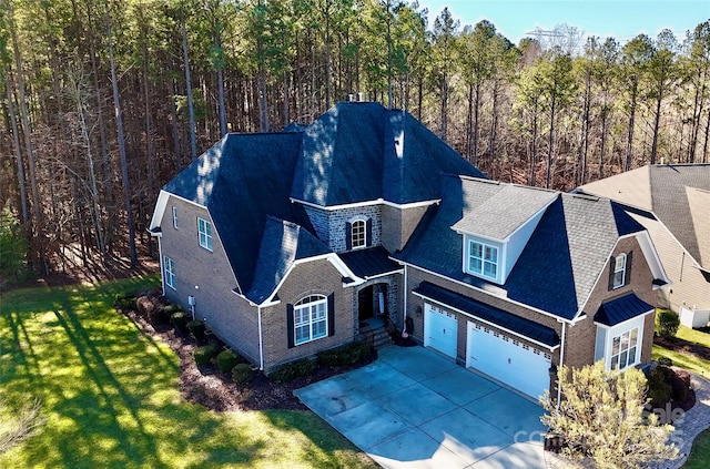 birds eye view of property featuring a wooded view