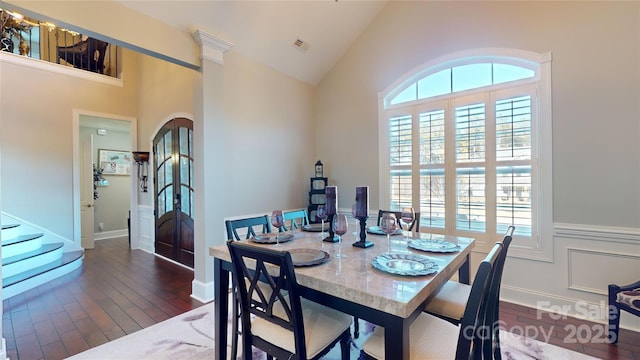 dining room featuring lofted ceiling and dark hardwood / wood-style flooring