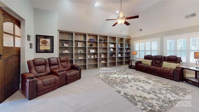 living room featuring visible vents, light carpet, high vaulted ceiling, and a ceiling fan