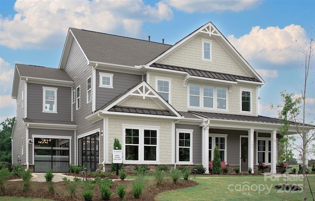 craftsman-style house featuring a garage and a front yard