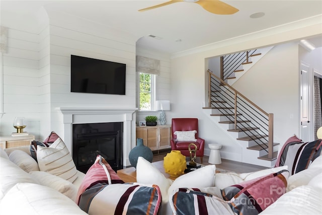 living room with crown molding and ceiling fan