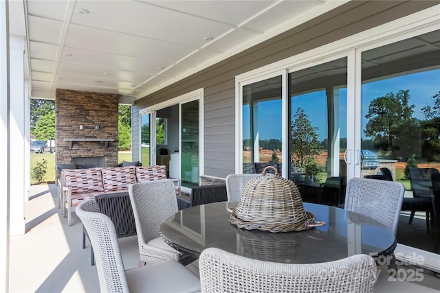 view of patio featuring an outdoor stone fireplace