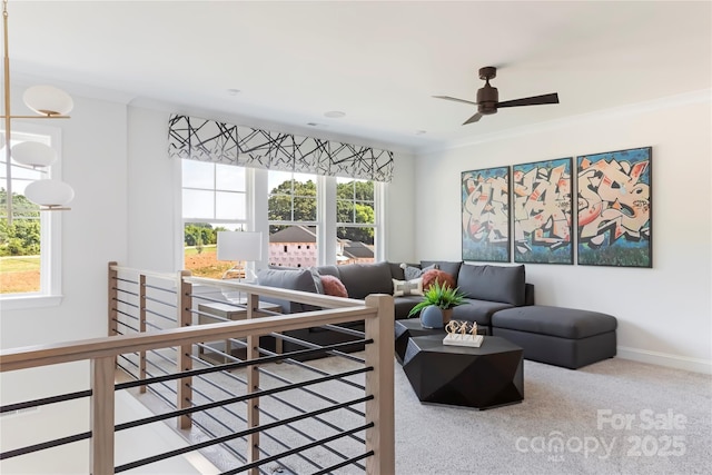 living room with ornamental molding, ceiling fan, and carpet