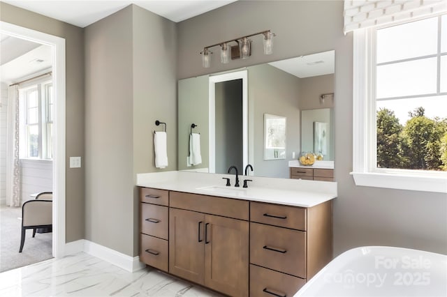 bathroom featuring vanity and a bath