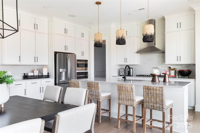 kitchen with white cabinetry, appliances with stainless steel finishes, sink, and hanging light fixtures