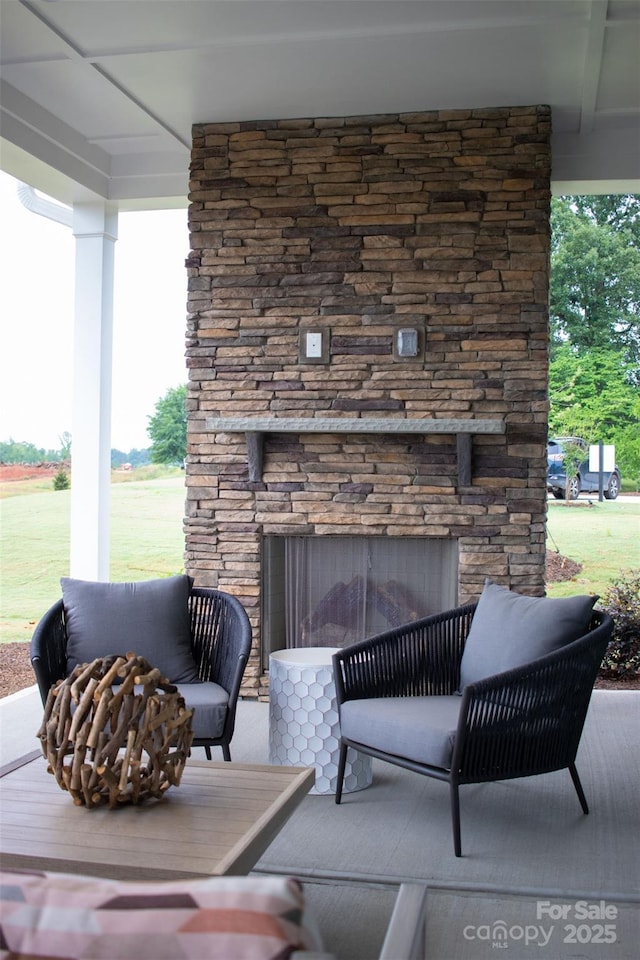 view of patio / terrace featuring an outdoor stone fireplace