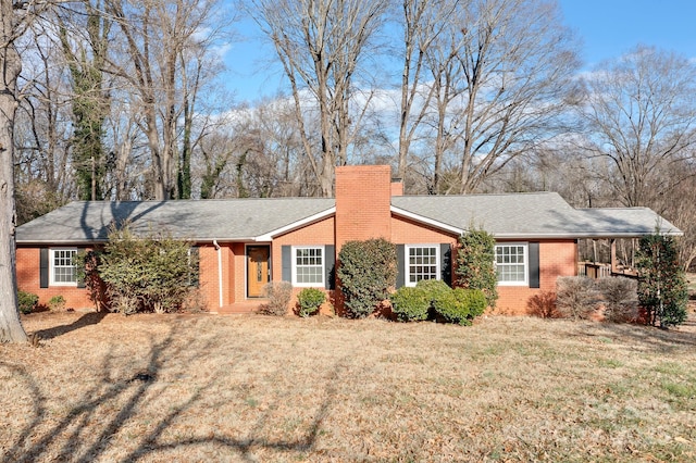 single story home featuring a carport and a front yard