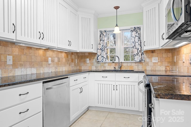 kitchen with light tile patterned flooring, sink, decorative light fixtures, stainless steel appliances, and white cabinets