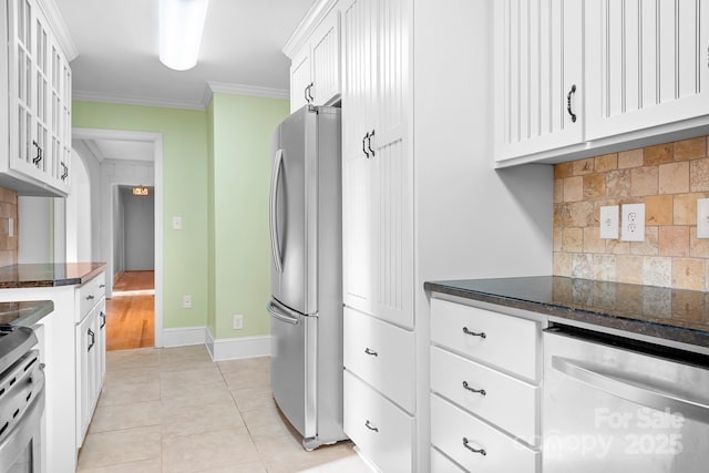 kitchen featuring light tile patterned floors, crown molding, stainless steel appliances, white cabinets, and decorative backsplash