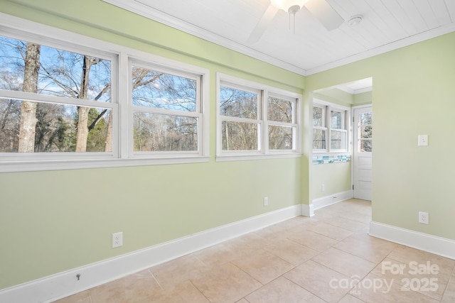 tiled empty room featuring crown molding and ceiling fan