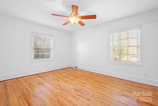 unfurnished room featuring ceiling fan and hardwood / wood-style floors