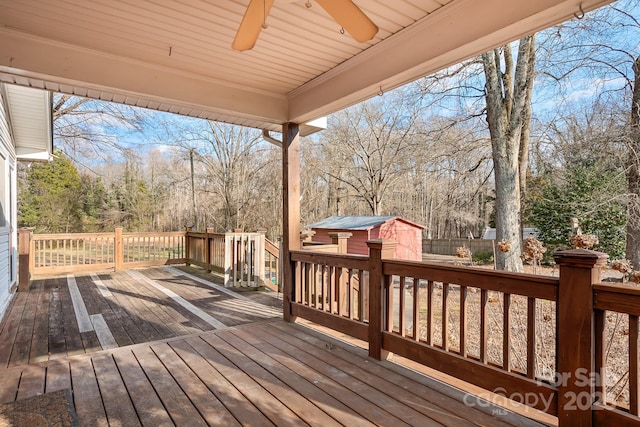 deck featuring ceiling fan and a storage shed