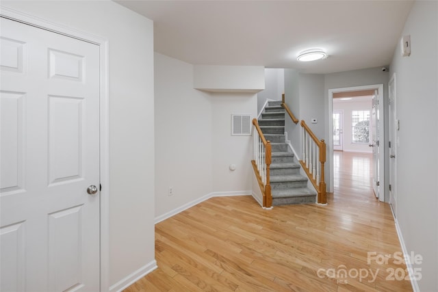 staircase featuring wood-type flooring