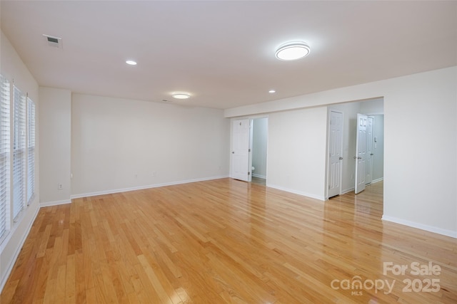 empty room with light hardwood / wood-style flooring