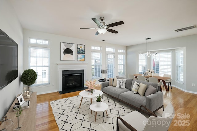 living room with ceiling fan and light hardwood / wood-style floors