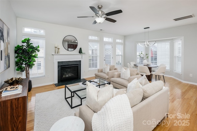 living room with ceiling fan and light hardwood / wood-style flooring