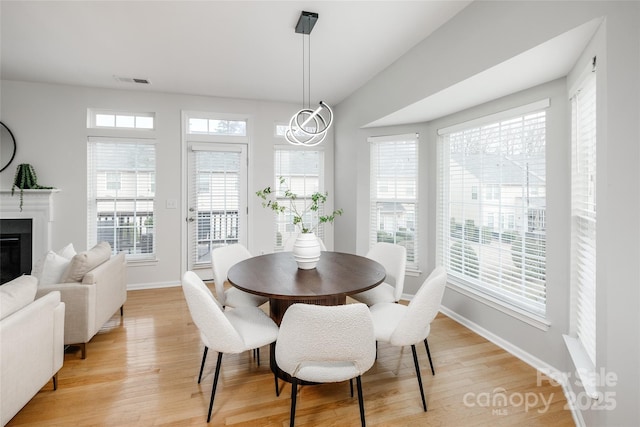 dining space with an inviting chandelier and light wood-type flooring