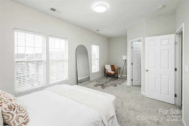 bedroom featuring light carpet