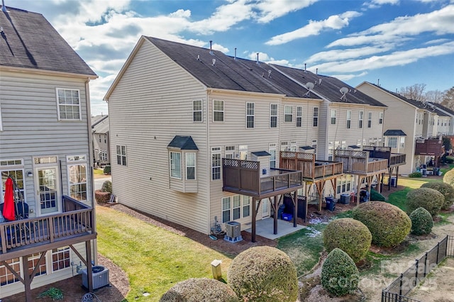 rear view of property featuring a yard and cooling unit