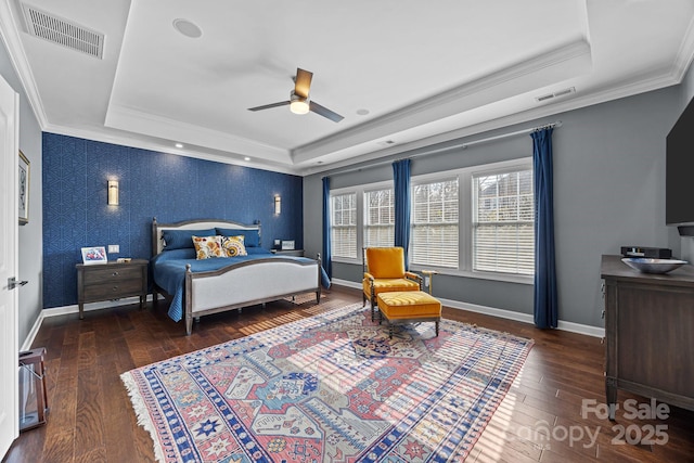 bedroom with ceiling fan, ornamental molding, and a raised ceiling