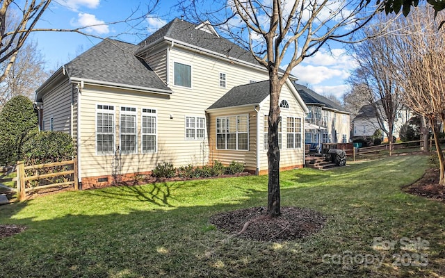 rear view of house featuring a lawn