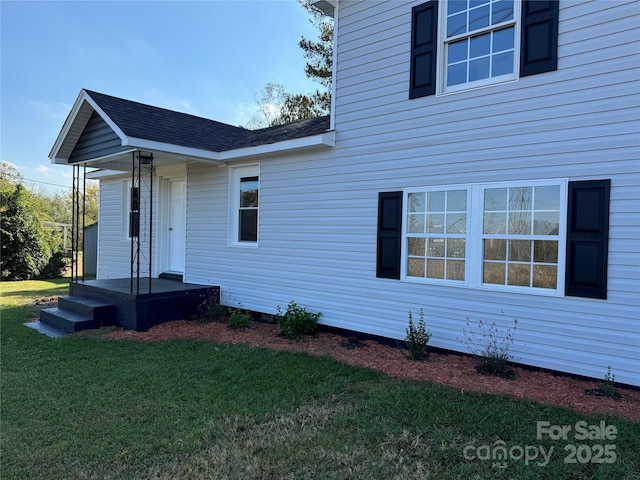 view of property exterior with a yard