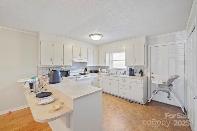 kitchen with white cabinetry, white electric range oven, ornamental molding, a kitchen bar, and kitchen peninsula