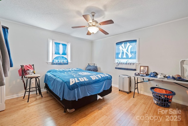 bedroom featuring crown molding, wood-type flooring, a textured ceiling, and ceiling fan