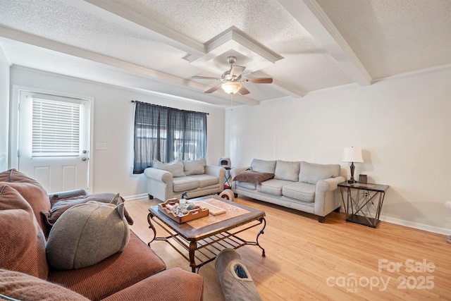 living room featuring beamed ceiling, ceiling fan, hardwood / wood-style floors, and a textured ceiling