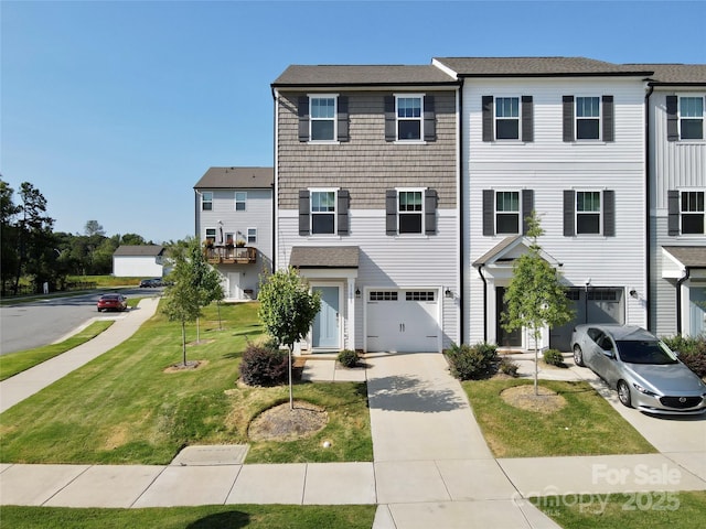 view of property featuring a garage and a front yard