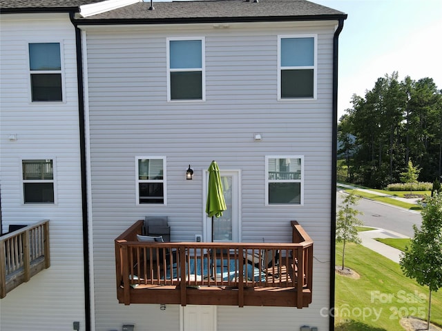 back of house featuring a deck