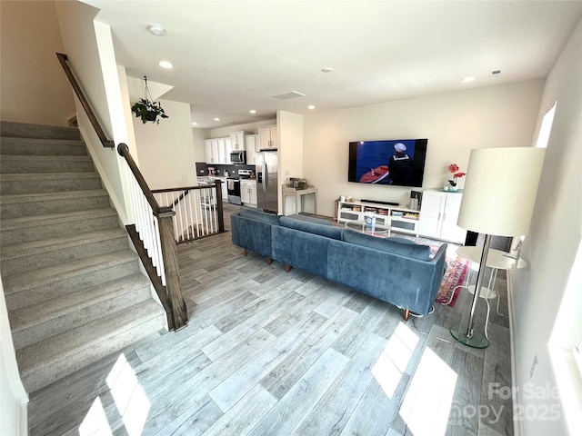 living room with light hardwood / wood-style flooring