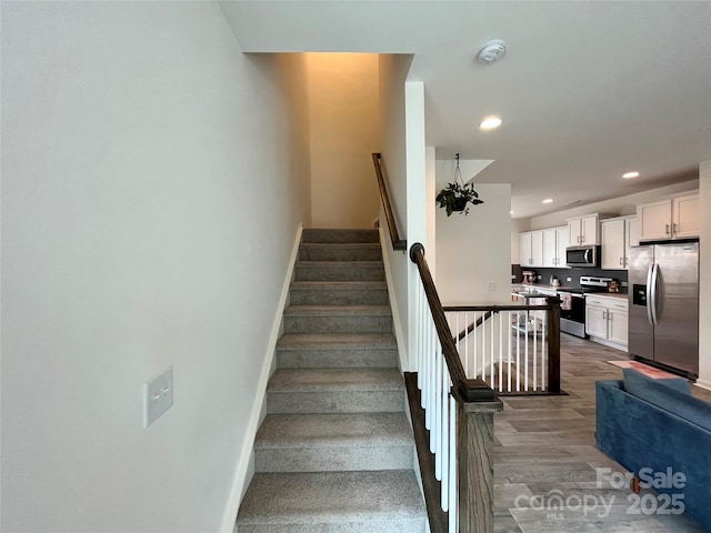 staircase featuring hardwood / wood-style flooring