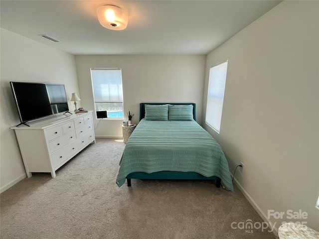 bedroom with light colored carpet